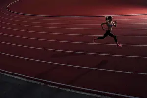 Agility Prints: High angle view of young female athlete running on race track