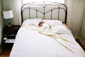 Life Styles Prints: High angle view of young girl lying on her side in a bed, sleeping