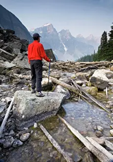 50 54 Years Prints: Hiker on Moraine Creek with Wenkchemna mountain range background