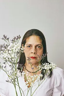 Baby Boomer Prints: Hispanic Woman holding Baby's breath flower