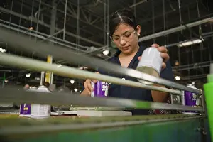 Lifting Prints: Hispanic woman working in manufacturing plant