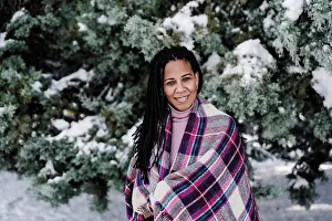 Upper Body Prints: Hispanic woman wrapped in shawl at park during winter