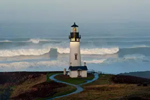 Secure Prints: The historic Yaquina Head tower lighthouse on a headland overlooking the Pacific coastline