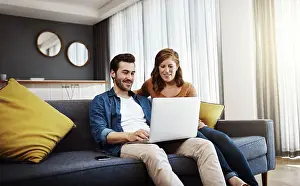Investment Prints: Home, smile and couple with laptop on sofa for online travel booking