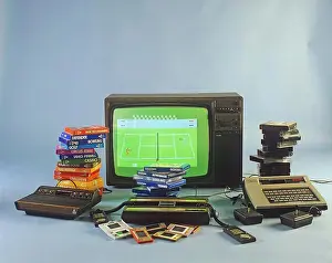 Electronics Prints: Home video games in the 1980s. A selection of the most popular game entertainment products in front of a television set