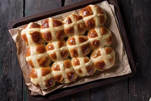 Back Ground Prints: Homemade Easter traditional hot cross buns on oven tray with baking paper over dark wooden background