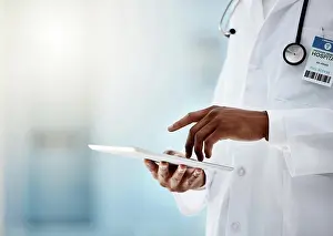Hospital, health and doctor with tablet and stethoscope