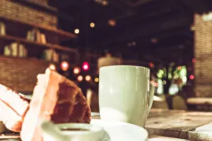 Lunch Prints: Hot mocha coffee in white cup and blurred waffle on the wooden table