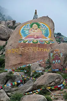 Giant Prints: Huge Buddha painted on a rock behind the Drepung temple, Lhasa, Tibet, Asia