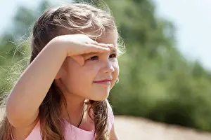 Draussen Prints: Image of cute little girl covers her eyes from sun Image of cute little girl covers her eyes from sun
