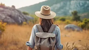 Travelling Prints: Image Generative AI. Young woman walking alone in nature