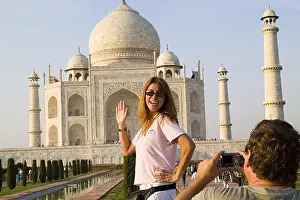 Visitor Prints: India, Agra, tourist man taking a photo of tourist woman in front of the Taj Mahal