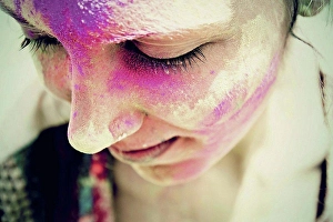 Holi Prints: India, Ahmedabad, Young woman celebrating holi festival with powder paint