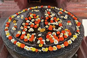 Human Foot Prints: India, Bihar, Feet of Buddha covered with flowers outside Mahabodhi Temple; Bodhgaya
