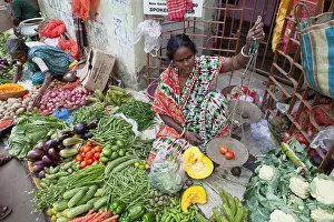 Vegetables Prints: India, West Bengal, Kolkata, Vendor in the vegetable market in the Garia district