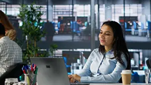 Indian businesswoman conducting a video call to review financial strategies with her colleagues