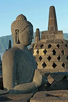 Culture Prints: Indonesia, Java, Borobudur, Seated, granite Buddha with small stupas in the background