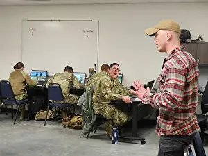 Wisconsin Prints: Instructor Aaron Wallander with the Fort McCoy Virtual Battle Space simulations facility talks with students Jan