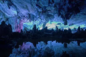 Features Prints: Interior of limestone cave with stalactites and stalagmites reflected in pool