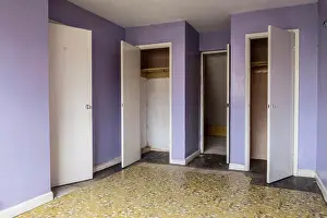 Residential Structure Prints: Interior view of empty bedroom with yellow floor and lilac walls in abandoned house