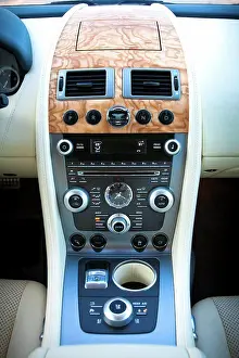 2012 Prints: Interior view of a blue 2012 Aston Martin Rapide showing the center console and dashboard from the rear