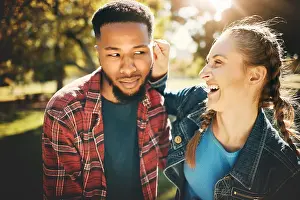 Laugh Prints: Interracial couple, laughing and smile in nature for playful love