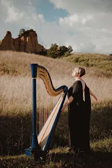Firenze Prints: Italy, Tuscany, Firenze, Woman standing in field with harp