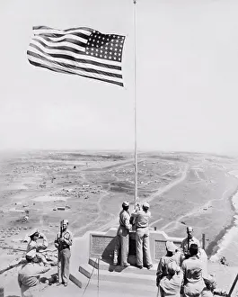 Monument Prints: Iwo Jima, Japan: c. 1955 An American flag ceremony at the monument on Mt