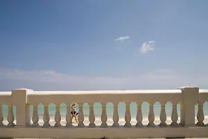 Traveller Prints: Jamaica, Montego Bay, Woman walks along white sand beach at Rose Hall Hotel