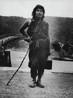1950 Prints: Japanese Tramp poses near famous Iwakuni Bridge. June 20, 1950