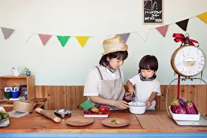 Work Tool Prints: Japanese woman and boy standing in a farm shop, preparing food
