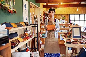 Leather Prints: Japanese woman wearing apron standing in a leather shop