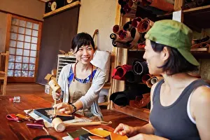 Leather Prints: Two Japanese women sitting at a table, working in a leather shop