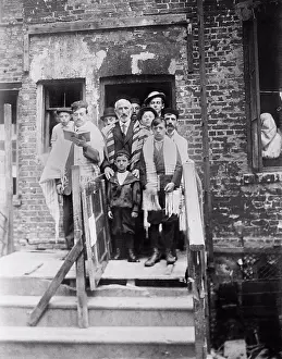 Celebrations Prints: Jewish men and boys in prayer shawls standing in front of a dilapidated tenement synagogue on Yom Kippur