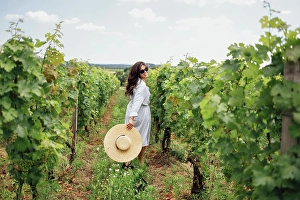 Palme Prints: Joyful woman, wearing a hat, in a vineyard in the sun Joyful woman
