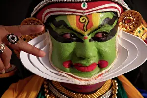 Colourful Prints: Kathakali dancer giving eye expressions with a smile on his face during a performance