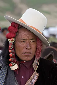 Verticals Prints: Khampa with jaunty cowboy hat and ivory hair peices at the Litang Horse Festival in Kham - Sichuan Province
