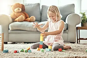 Kid, playing alone and toys on living room floor