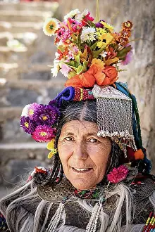 Looks Into The Camera Prints: Ladakh, India, August 29, 2018: Portrait of an indigenous elderly woman with traditional flower hat in Ladakh