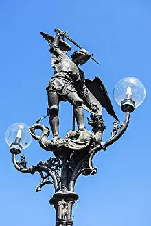 Flanders Prints: Lantern post with statue of Archangel Michael slaying Satan as a dragon at Saint Michael's Bridge in Ghent