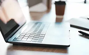 Notebook Prints: Laptop, computer and desk with a notebook on a table in an empty office at work