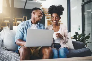 Typing Prints: Laptop, laughing and black couple on sofa for online