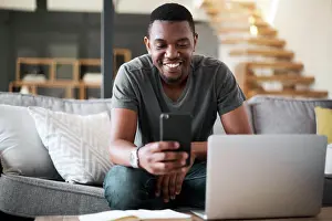 Contact Prints: Laptop, phone and man on sofa for remote work