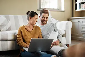Partnership Prints: Laptop, planning and documents with couple in living room for investment portfolio