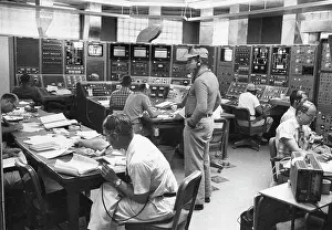Atomic Prints: In a large room lined with instrument panels
