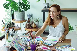 Paint Prints: Latin artist painting with watercolor in her studio