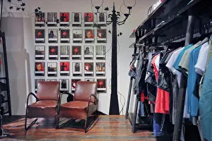 Leather Prints: Leather armchairs by clothing rack in store. Taipei, Taiwan. 04/17/2010