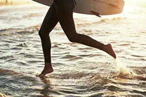 Swimming Prints: Legs, running and surfboard in ocean for workout