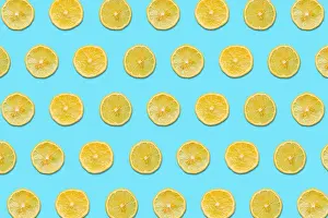 Whimsical Prints: Lemon Slices on a Blue Background in a Pattern