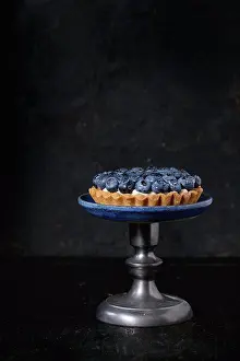 Dessert Prints: Lemon tartlet with fresh blueberries, served on vintage cake stand over black background